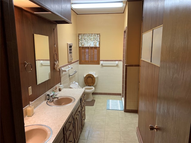 bathroom featuring toilet, double vanity, and tile flooring