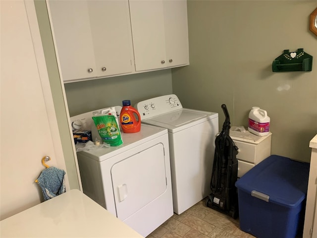 washroom featuring cabinets, separate washer and dryer, and light tile floors