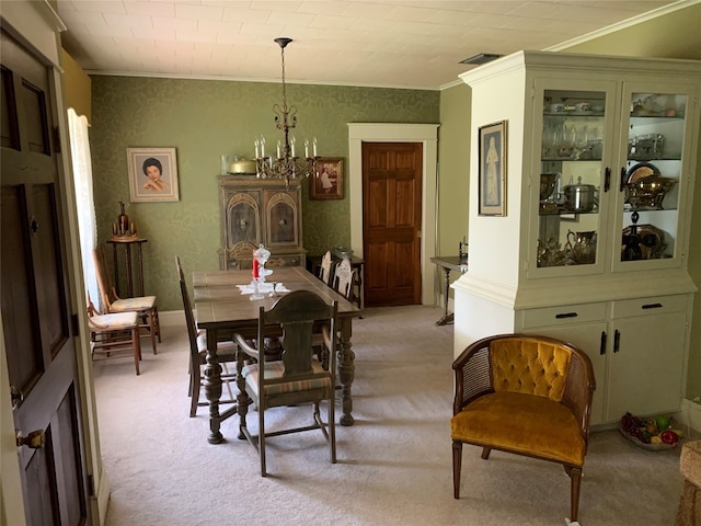 dining space featuring a notable chandelier, ornamental molding, and light carpet