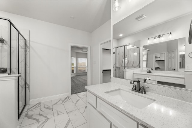 bathroom featuring an enclosed shower, vanity, and tile flooring