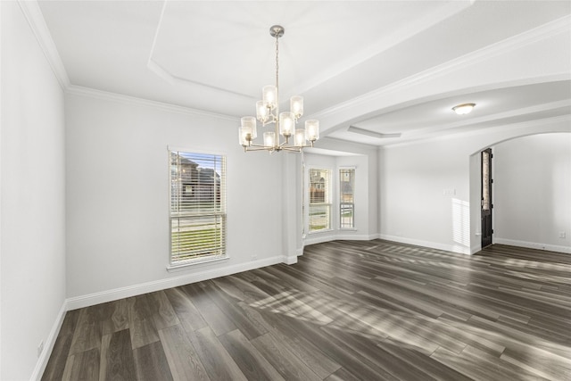 unfurnished living room featuring a chandelier, a tray ceiling, dark wood-type flooring, and crown molding