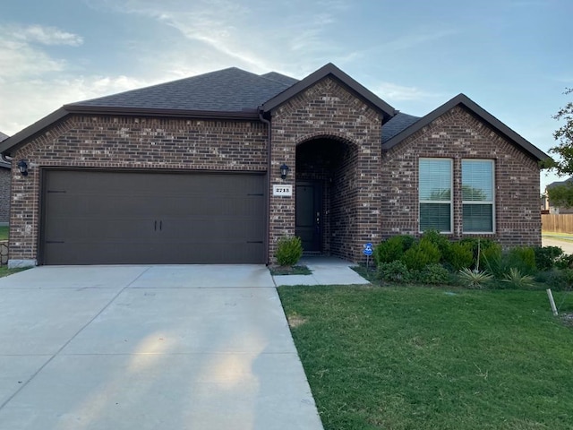 view of front of house with a front yard and a garage