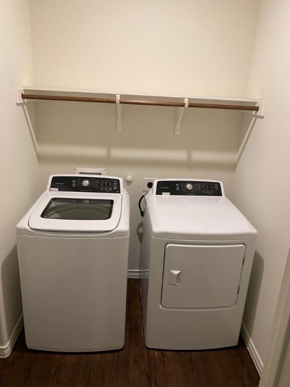 laundry room with hookup for an electric dryer, washing machine and clothes dryer, and dark hardwood / wood-style floors