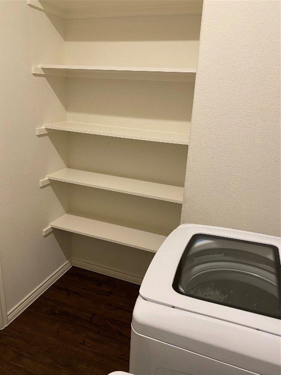 clothes washing area featuring dark wood-type flooring