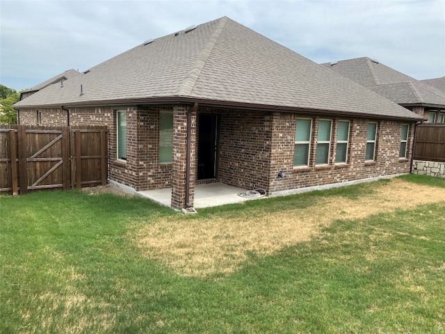 back of house featuring a yard and a patio