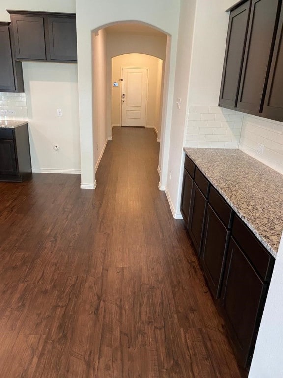 corridor with dark hardwood / wood-style flooring