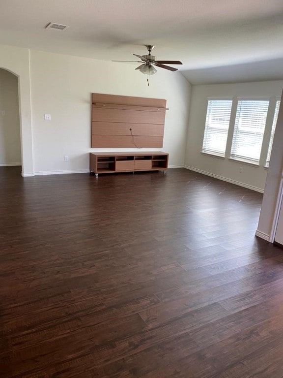 unfurnished living room featuring ceiling fan and dark wood-type flooring