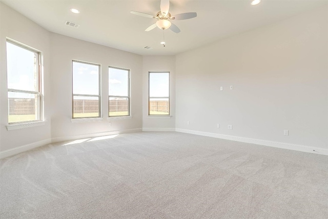 empty room with light colored carpet and ceiling fan