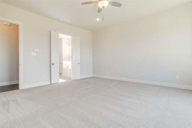 unfurnished room featuring light carpet and ceiling fan