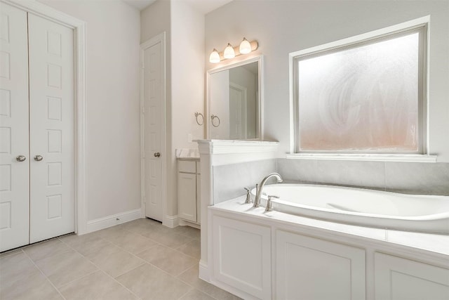 bathroom with tile floors, a bathtub, and a wealth of natural light