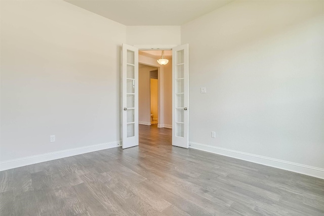 unfurnished room with french doors and dark hardwood / wood-style flooring