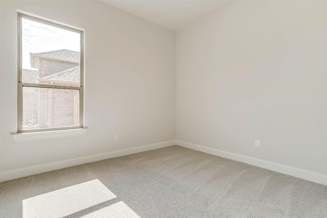 unfurnished room featuring a wealth of natural light and light carpet