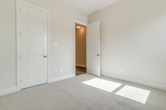 unfurnished bedroom featuring dark colored carpet