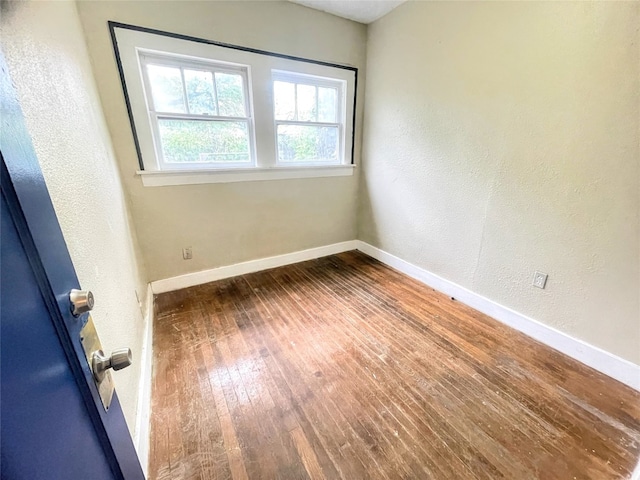 spare room with dark wood-type flooring