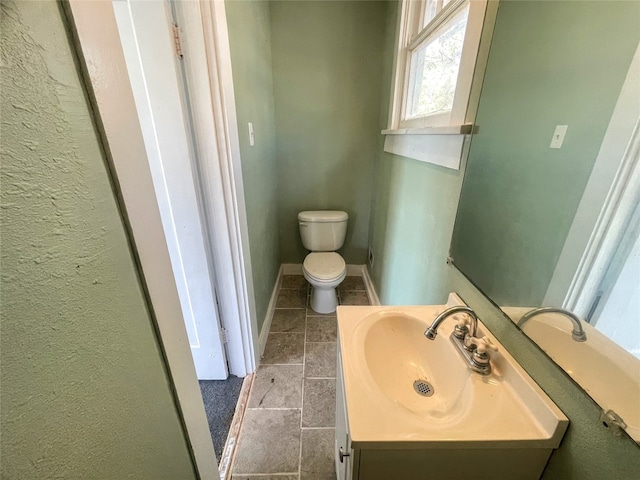 bathroom with vanity, tile floors, and toilet