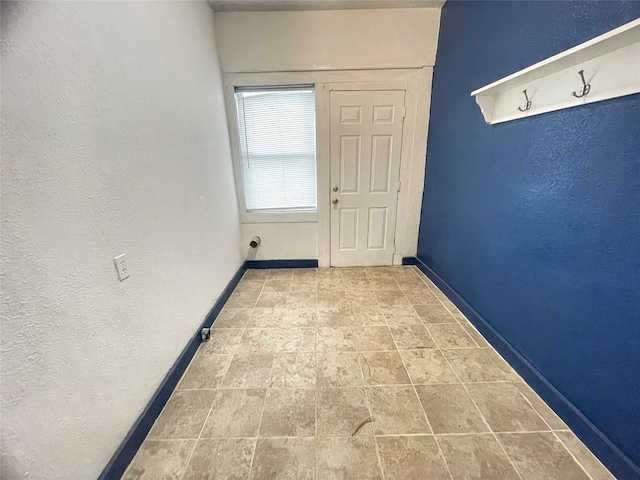 doorway to outside with light tile floors