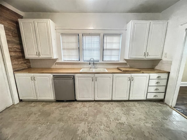 kitchen featuring white cabinetry, light tile flooring, sink, stainless steel dishwasher, and tasteful backsplash