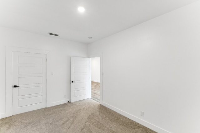 unfurnished room with light colored carpet