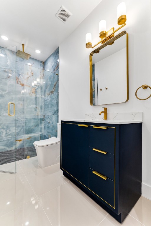 bathroom featuring tile flooring, an enclosed shower, and vanity