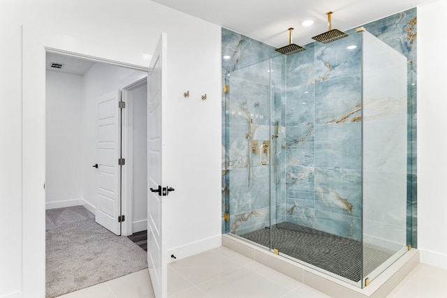 bathroom featuring a shower with door and tile flooring