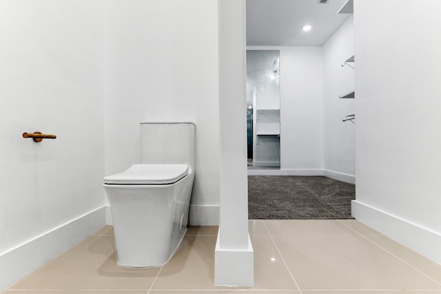 bathroom featuring toilet and tile flooring