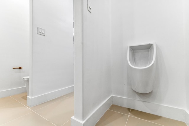 bathroom with toilet and tile flooring