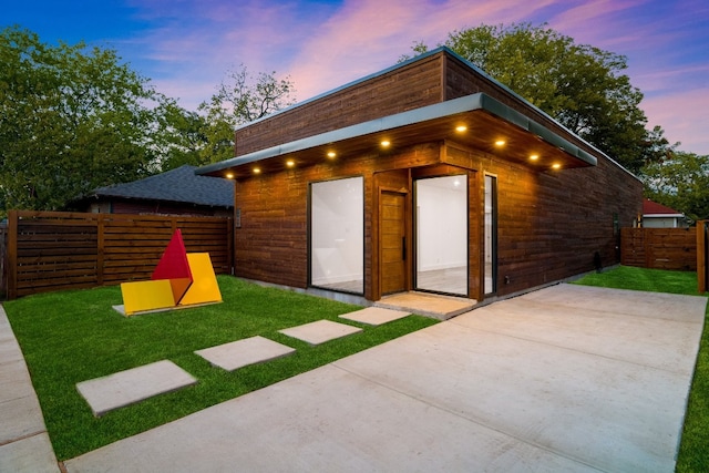 outdoor structure at dusk with a lawn