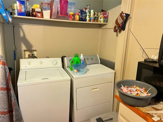 laundry room featuring hookup for a washing machine and washing machine and clothes dryer