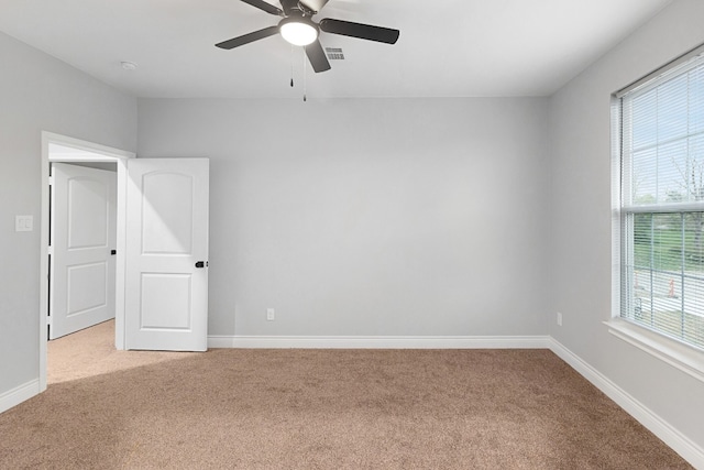 unfurnished room with ceiling fan and light colored carpet