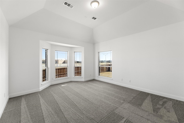 empty room featuring carpet and vaulted ceiling