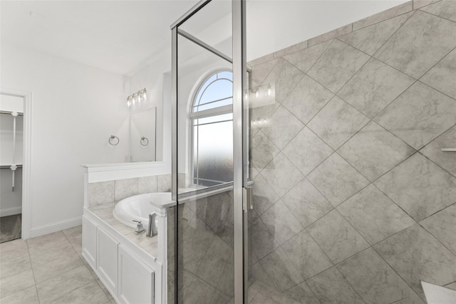 bathroom featuring tile floors and independent shower and bath