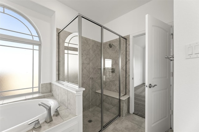 bathroom featuring tile floors and separate shower and tub