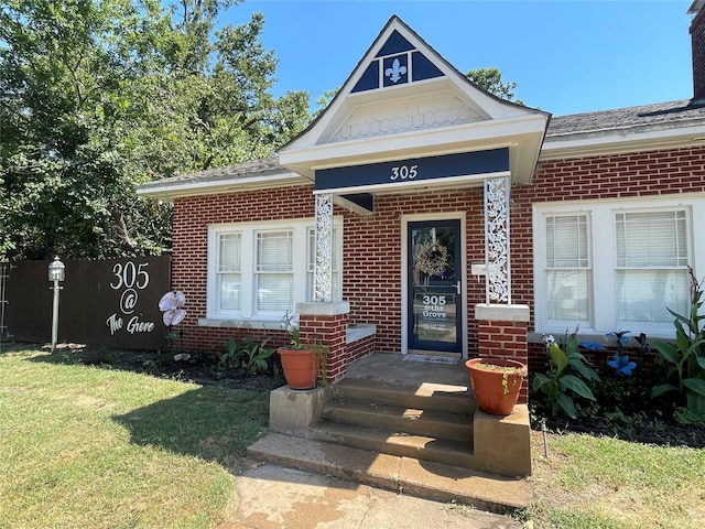 entrance to property with a lawn