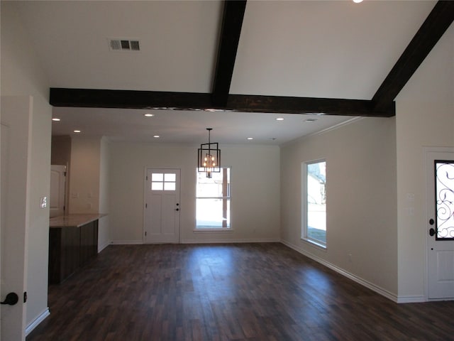 foyer entrance with a chandelier, dark hardwood / wood-style flooring, and beamed ceiling