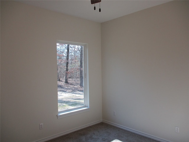 carpeted empty room with a healthy amount of sunlight and ceiling fan