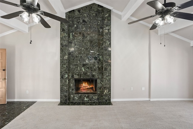 unfurnished living room featuring a premium fireplace, ceiling fan, vaulted ceiling with beams, and carpet flooring