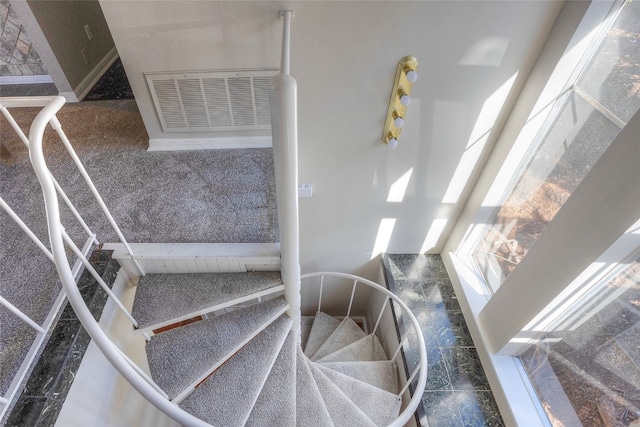 stairway featuring tile patterned flooring