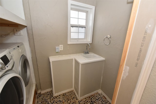 laundry room featuring washer and clothes dryer, sink, and tile flooring