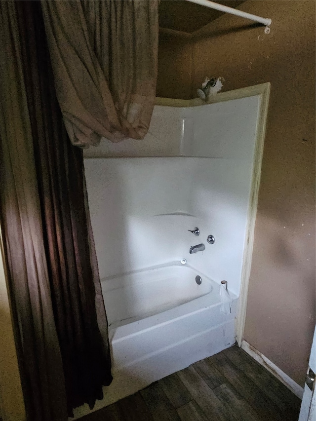 bathroom featuring shower / tub combo and hardwood / wood-style flooring