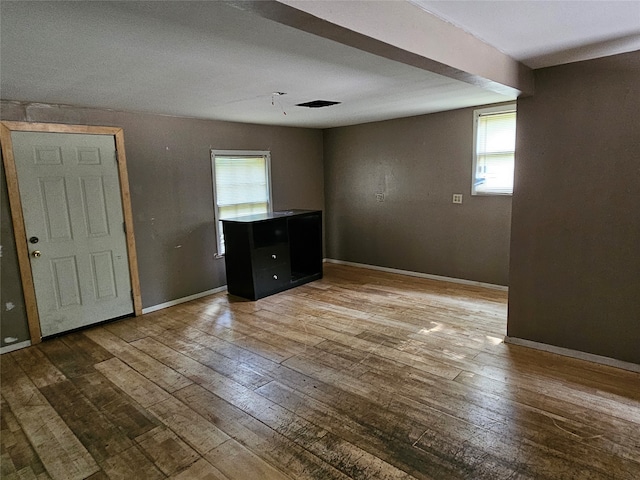 spare room with hardwood / wood-style flooring