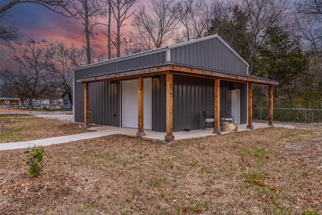 view of garage at dusk