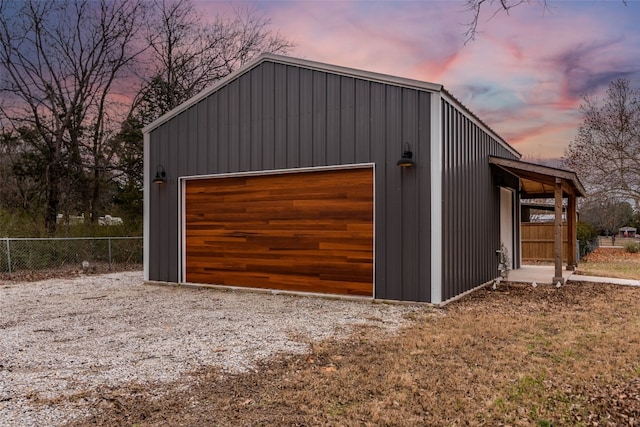 view of garage at dusk