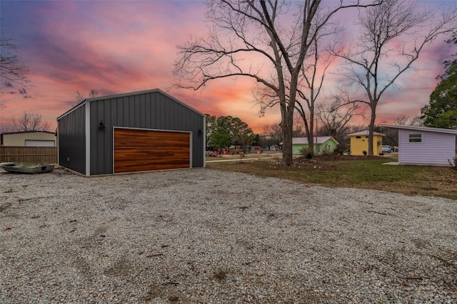 view of garage at dusk