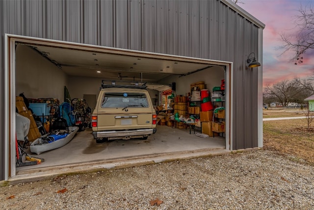 view of garage at dusk