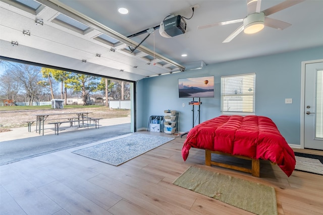 garage featuring a garage door opener and ceiling fan