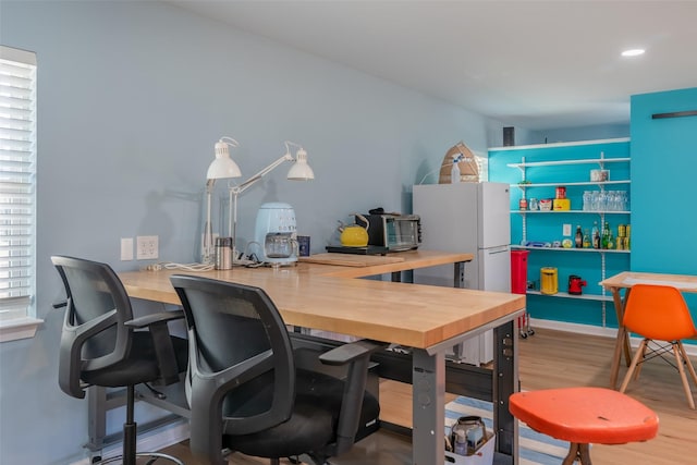 home office with hardwood / wood-style floors