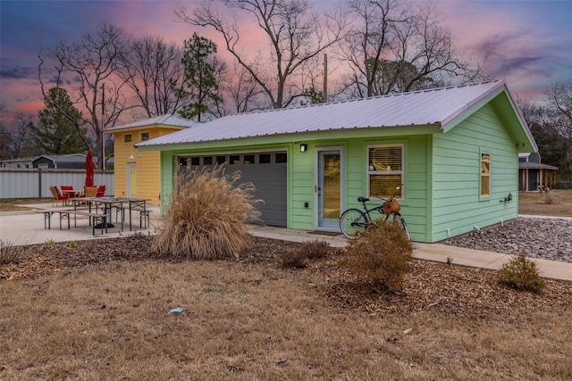 ranch-style home with a garage and a patio