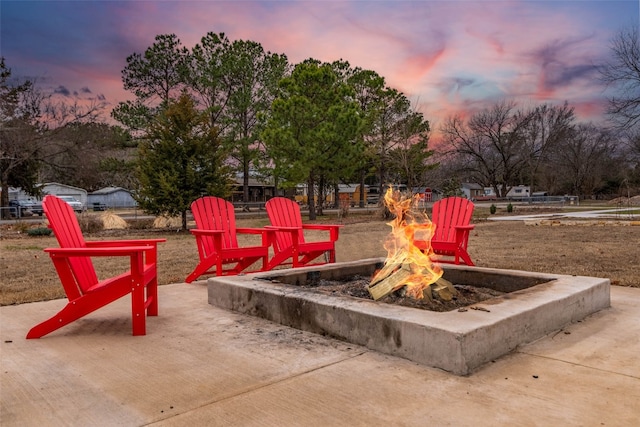 view of property's community featuring a fire pit and a patio area