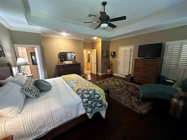 bedroom with ceiling fan, a closet, a raised ceiling, dark hardwood / wood-style flooring, and ornamental molding