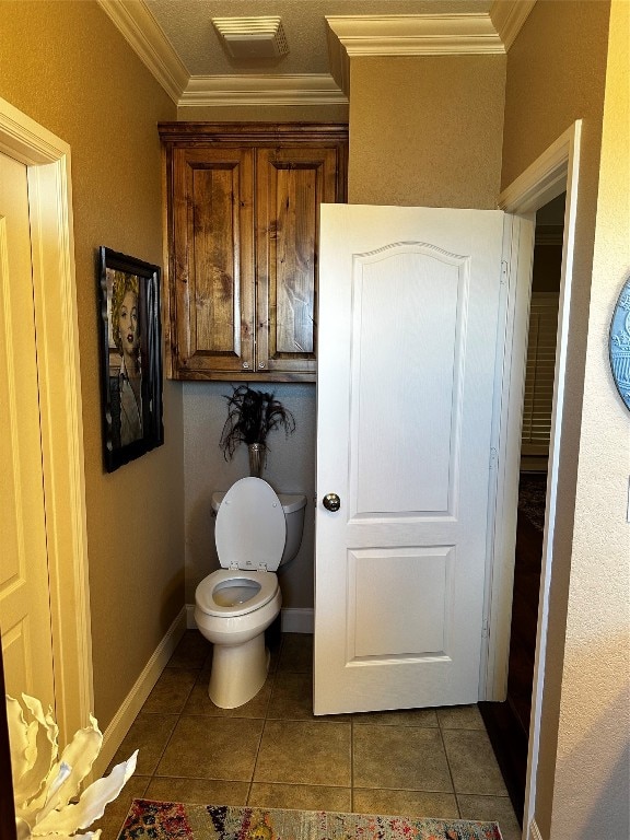 bathroom with toilet, tile flooring, and ornamental molding